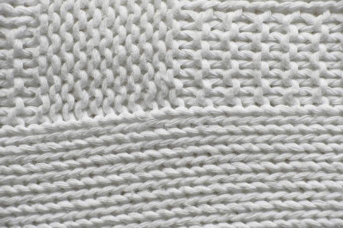 white knit textile on white surface