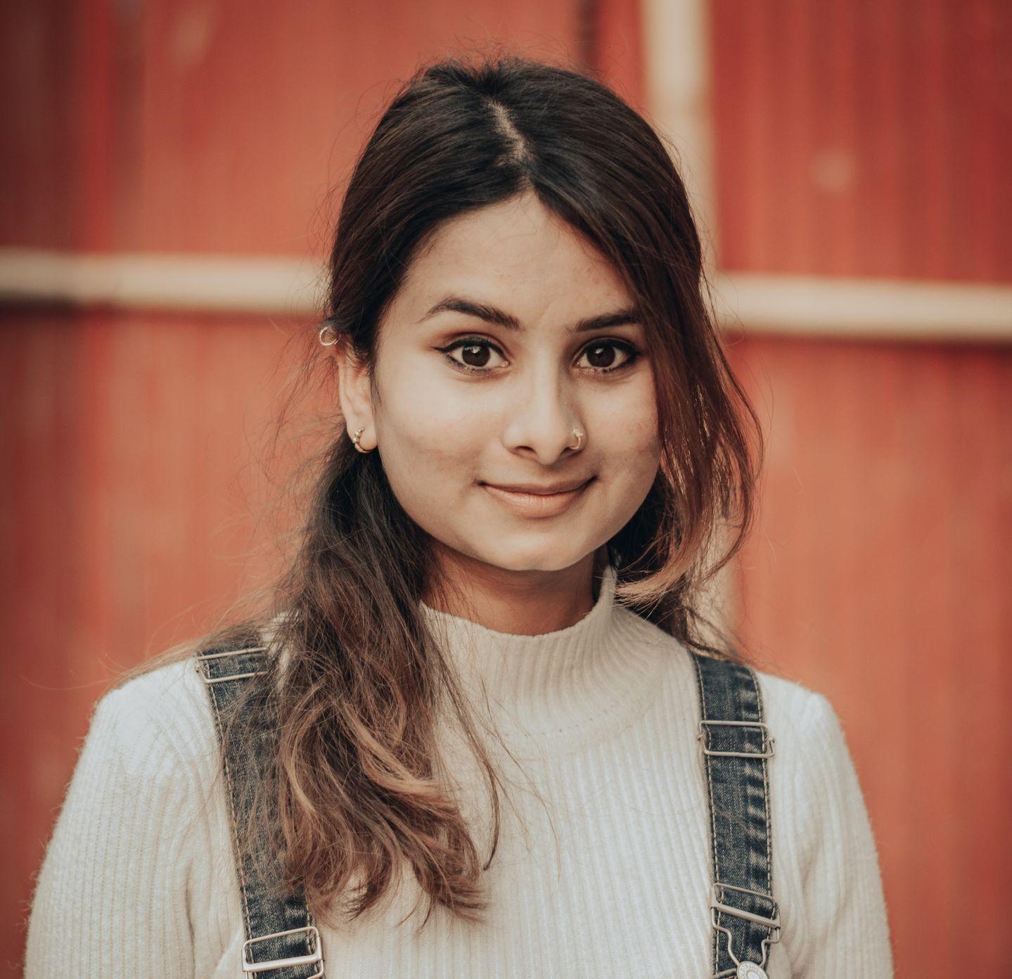 woman in white long sleeve shirt and blue denim dungaree